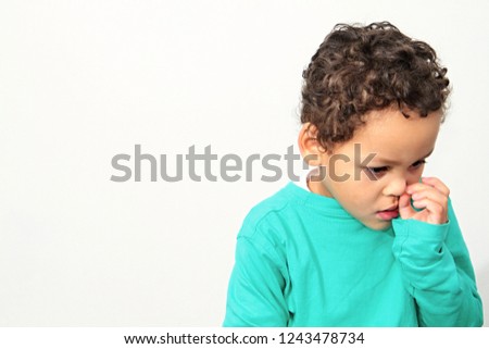 Little boy picking his nose on white background stock photography stock photo
