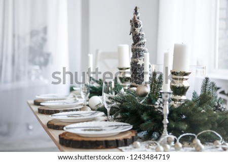 Table served for Christmas dinner in living room, close up view Royalty-Free Stock Photo #1243484719