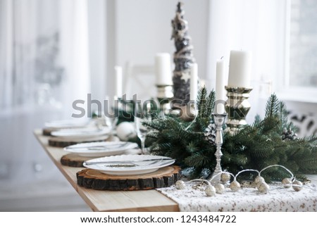 Table served for Christmas dinner in living room, close up view Royalty-Free Stock Photo #1243484722