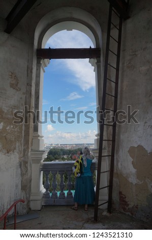 tourists take pictures of the cathedral from the bell tower