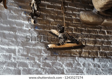 Ancient Dutch ice skates hanging on a wall