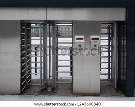 close up of chrome turnstiles with electronic tickets check. outdoor winter shot