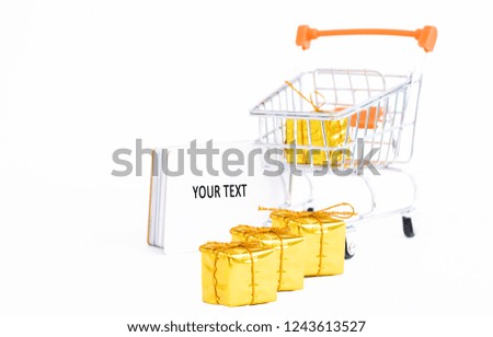 mini cart with small golden gift boxes and discount cards isolated on white background with copy space.