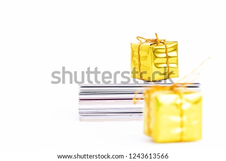 mini golden gift boxes and stack of discount cards isolated on white background with copy space.