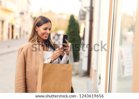 Woman taking picture of herself in the city