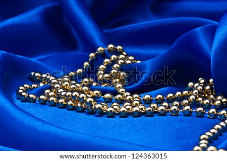 Necklace against blue silk