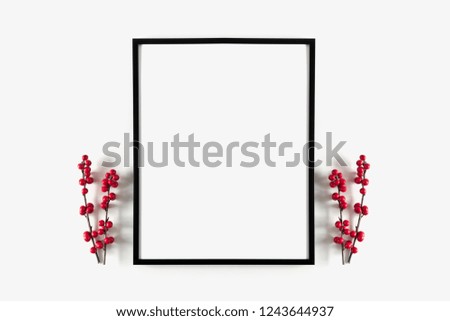 Christmas modern composition. Photo frame, red  berries on white background. Christmas, New Year, winter concept. Flat lay, top view, copy space
