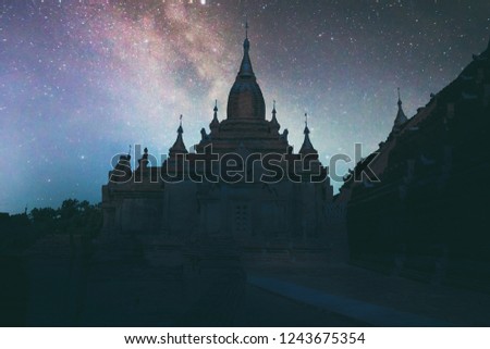 Abstract vintage tone long exposure photography of Ancient temple in Bagan, Myanmar in the night time with milky way and stars on the night sky background.