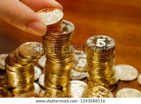 Saving money concept preset by feale hand putting money coin stack growing business,chinese rmb.