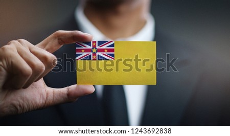Businessman Holding Card Niue Flag 