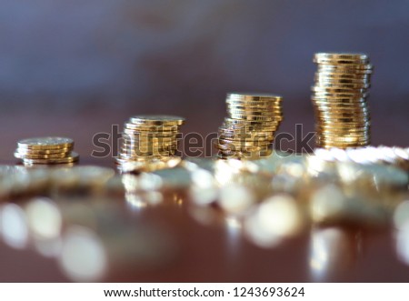 piles of golden Chinese coins on the table. The concept of wealth fund savings and financing.
