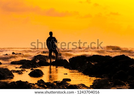 Silhouette Photographer take photo beautiful seascape at sunrise in Malaysia.
