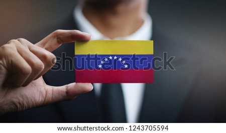 Businessman Holding Card of Venezuela Flag 