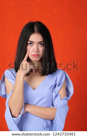 Worry entrepreneur woman  on pink background, beautiful woman wearing blue hat looking serious or thinking about something , female with hand on face so sadness about problem