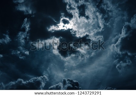 Moonlight shines behind a cloudy at night. serenity nature background.