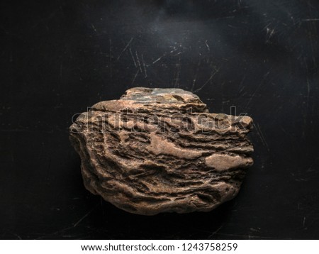 Weathered Rock On Dark Scratched Background. Legendary Artifact of Power, Courage and Healing Symbol Concept.