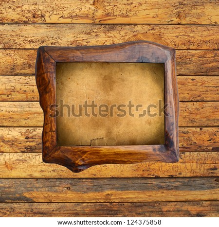 Empty frame on wooden wall