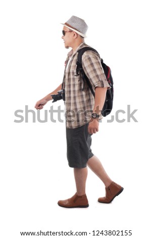 Traveling people concept. Portrait of Asian male backpacker traveler tourist  isolated on white. Full body portrait. Walking side view
