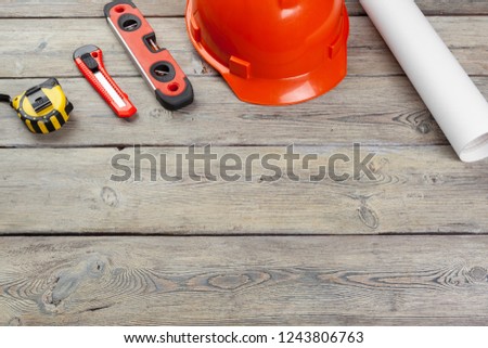 Construction  worker supplies and instruments on wooden background