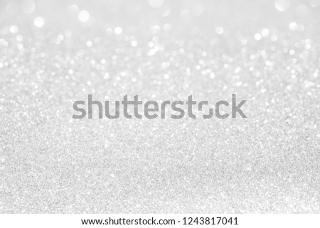 glitter vintage lights background. silver and white. de-focused