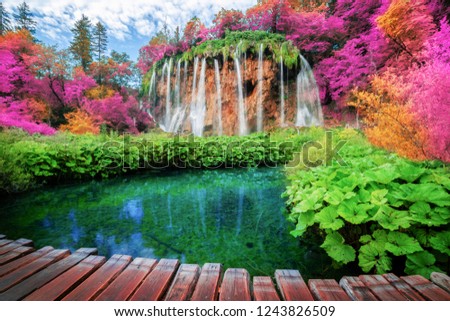 Beautiful wooden path trail for nature trekking with lakes and waterfall landscape in Plitvice Lakes National Park, UNESCO natural world heritage and famous travel destination of Croatia. Royalty-Free Stock Photo #1243826509