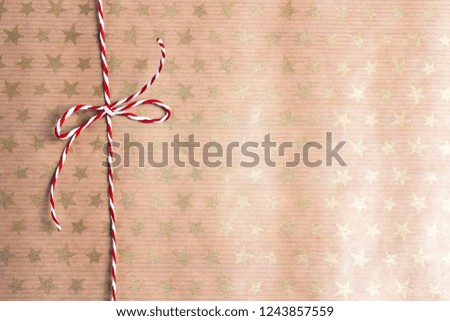 Wrapping paper background with stars and christmas ribbon. Copy space for text, top view, flat lay. 