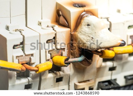 Melting and Damage of Electrical Fuse Box or Breaker Because of Overcurrent Power. Concept of Home Safety From Short Circuit Royalty-Free Stock Photo #1243868590