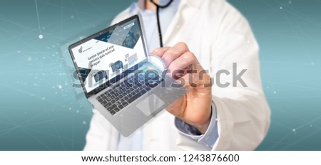 View of a Doctor holding a Laptop with business website template on the screen isolated on a background