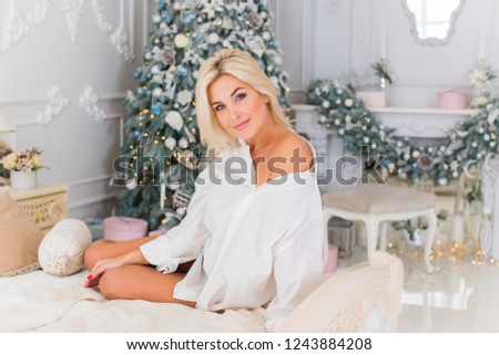 Woman celebrate Christmas at home. Holidays time. Lady at winters best days. Happy moments and good mood