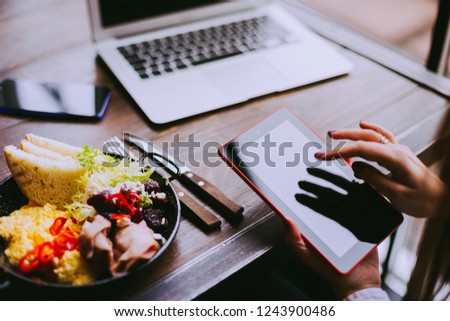 Workplace, business lunch,food delivery, vegetables and scrambled eggs with bacon in plate on wooden table. Breakfast.