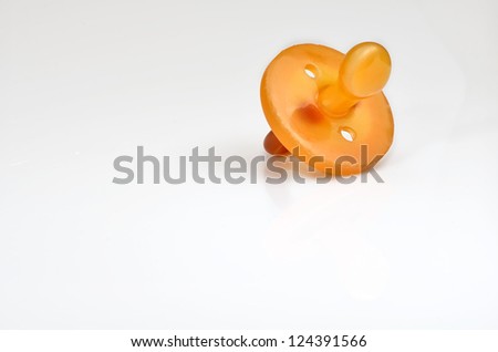 macro photograph of a silicone pacifier on white background