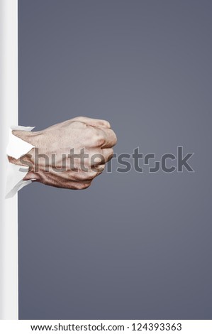 An image of fist punch through paper