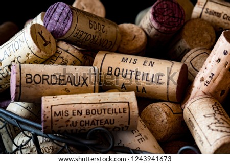 old cork stoppers of French wines in a wire basket Royalty-Free Stock Photo #1243941673
