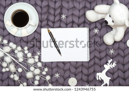 Christmas decor on a woolen blanket. A cup of hot coffee with marshmallows.Xmas card.New Year, holidays concept.