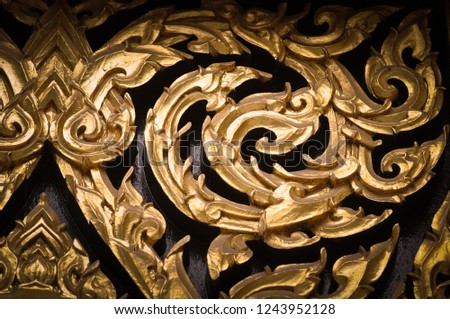 Closeup Thai pattern carving Kanok picture at door in temple