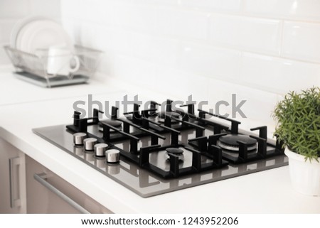 Modern built-in gas cooktop in light kitchen Royalty-Free Stock Photo #1243952206