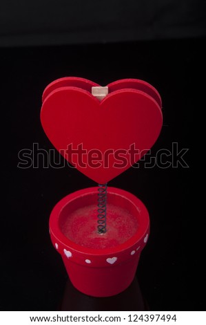 An image of red holder with heart and paper