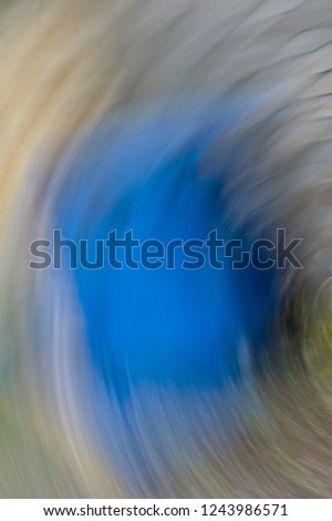 Impression with cobalt blue. The camera made a rotating motion while taking the picture. Vertical background photo