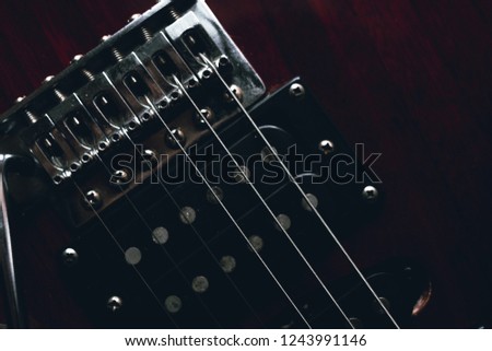 red electric guitar isolated on black background, closeup