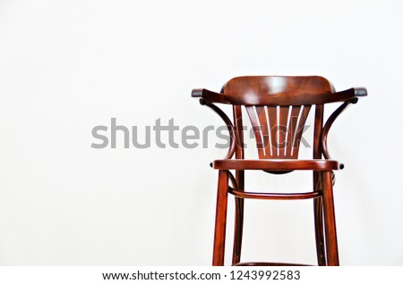 Wooden chair on light wall background with copy space for your text. Style minimalistic concept. Interior design