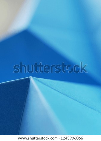 Blue paper folded, corners and triangles