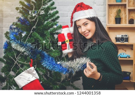 Beautiful young woman decorating christmas at home.