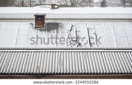 Industrial rooftop covered by winter snow, Welwyn Garden City station in Hertfordshire, England