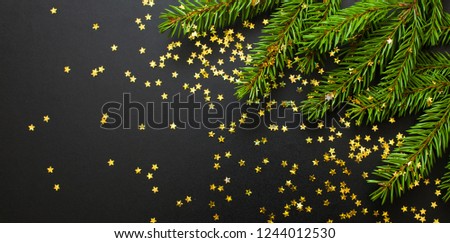 Panoramic Christmas background. Christmas tree sprinkled Golden stars scattered on black background. Wide Angle Web banner With Copy Space for text. Beautiful template for holiday greeting card