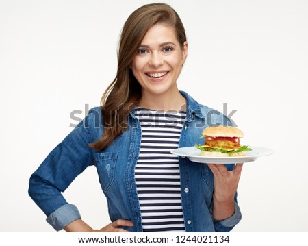 Portrait of smiling woman holding plate with cheese burger. Classic american fast food.
