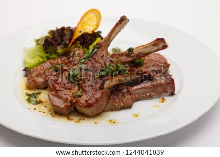 Grilled ribs on plate background Royalty-Free Stock Photo #1244041039