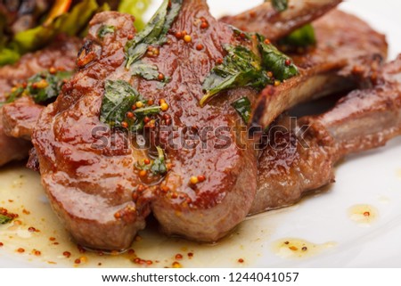 Grilled ribs on plate background Royalty-Free Stock Photo #1244041057