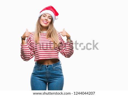 Young beautiful woman wearing christmas hat over isolated background looking confident with smile on face, pointing oneself with fingers proud and happy.