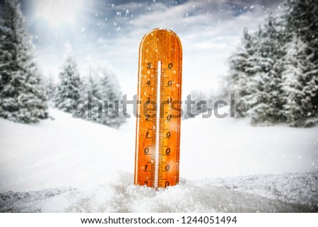 Winter photo of thermometer and snow decoration. 