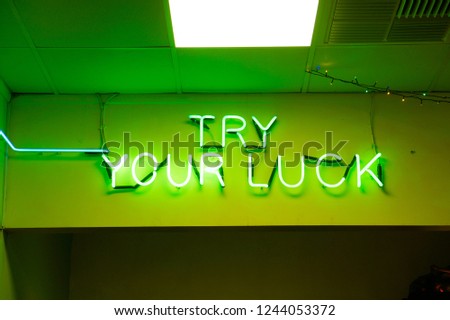 A green neon sign at a gaming arcade in the UK
